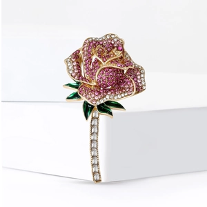 Elegant gold rose brooch with gradient pink rhinestones and green enamel leaf detail