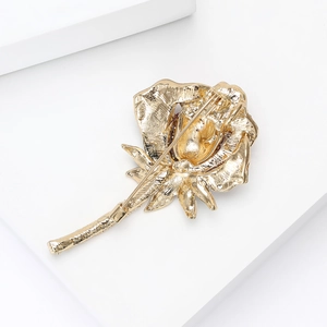 Detail view of the secure golden metal pin structure on the back of the rose brooch