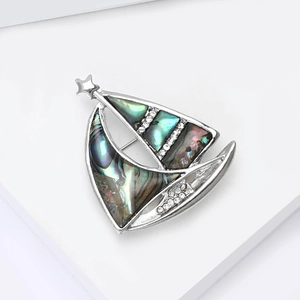 Vintage silver sailboat brooch with colorful abalone shell sails and sparkling rhinestones