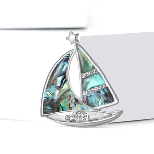 Elegant silver sailboat brooch featuring natural abalone shell and sparkling rhinestones
