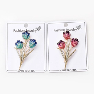 Detail of tulip brooches featuring colorful enamel petals and sparkling rhinestones
