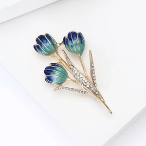 Detail of tulip brooch with blue-green enamel petals and sparkling crystal leaves