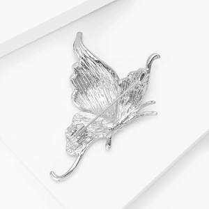 Detailed back view showing the secure pin fastener of a silver butterfly brooch