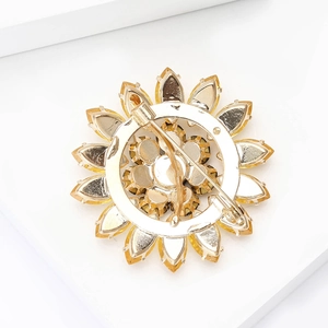 Macro view of the rotating safety pin and metal base on the sunflower brooch back