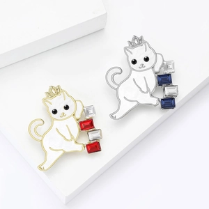 Elegant cat brooches with crystals on geometric display stands in gold and silver finish