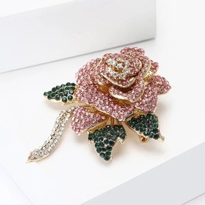 Detail of rose brooch with pink and green rhinestones on gold alloy base