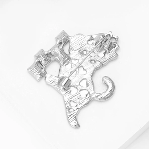 Rear view of silver cat brooch with heart cutouts and classic pin fastening mechanism