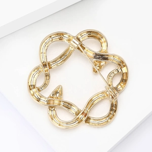 Detailed back view of gold snake brooch showing secure pin fastener and metal finish