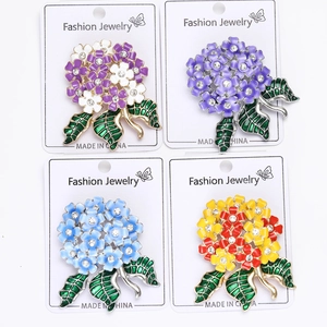 Detail view of four colorful enamel hydrangea brooches with sparkling rhinestone centers