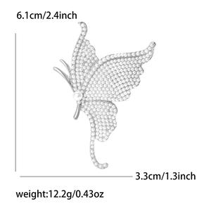 Detailed view of butterfly brooch dimensions 6.1cm by 3.3cm with pearl embellishments