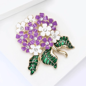 Detail of purple and white hydrangea brooch with crystals and green enamel leaves