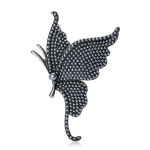 Elegant butterfly brooch in dark metal finish with small grey pearls on white background