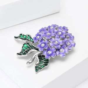 Detail of purple enamel hydrangea brooch with sparkling crystal petals and green leaf accents