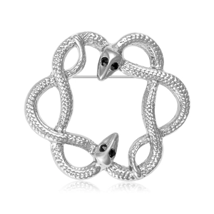 Silver interlocking twin snake brooch with scale texture and black crystal eyes on white background