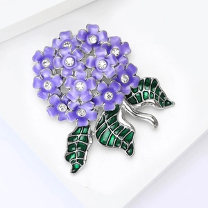 Detailed macro view of purple hydrangea flower brooch with crystal centers and green leaves