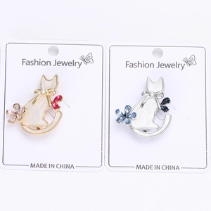 Detailed close-up of cute cat alloy brooches with rhinestones on fashion jewelry cards