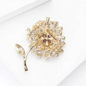 Detailed back view of golden hydrangea brooch showing the safety pin clasp and metal craft