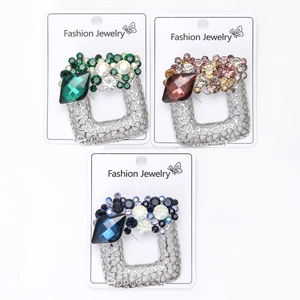 Three hollow square alloy brooches with emerald, burgundy and navy stones on white card