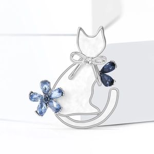 Elegant silver alloy cat brooch with white enamel, blue crystals, and sparkling rhinestones