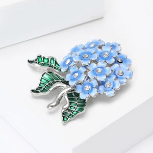 Detail of light blue enamel hydrangea brooch with sparkling crystal petals and green leaf