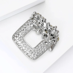 Back view of silver square rhinestone brooch with hollow alloy frame and safety pin