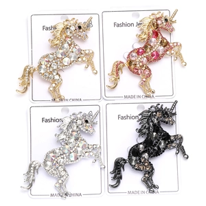 Detailed set of four rhinestone unicorn brooches in gold, silver, and black metal finishes