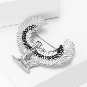 Macro detail of silver Egyptian wing goddess brooch with black enamel feathers