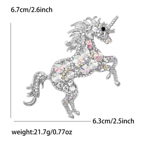 Detail view of rhinestone unicorn brooch showing dimensions 6.7cm by 6.3cm on white backdrop