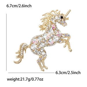 Golden unicorn brooch with rainbow AB crystals and white rhinestones on white background