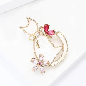 Detail of elegant gold cat brooch with sparkling rhinestones and floral gem accents