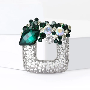 Hollow silver square brooch with emerald green gemstones and sparkling rhinestones