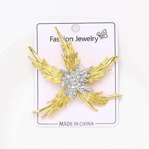 Macro view of gold-plated starfish brooch with sparkling crystal rhinestones center