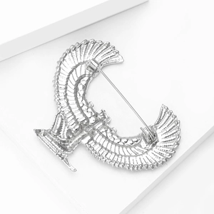 Detailed view of silver angel wing brooch with fine feather texture and pin clasp
