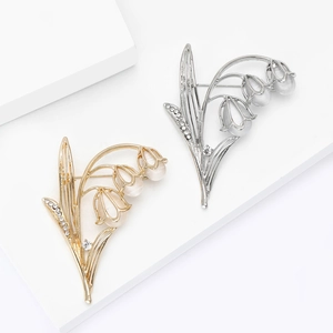Elegante Maiglöckchen-Brosche in Gold und Silber mit opalisierenden Katzenaugen-Steinen