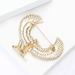 Detailed back view of golden Egyptian wing brooch showing the secure pin clasp closure