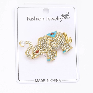 Detailed view of elephant brooch with sparkling rhinestones, blue enamel, and pearl accent