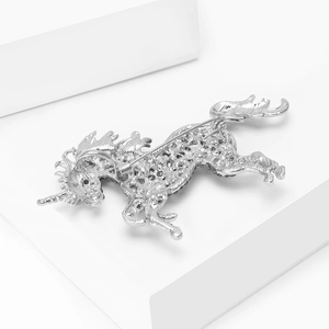 Detailed back view showing metal safety pin and honeycomb hollow base of unicorn brooch