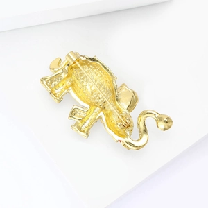Detailed back view of gold-plated elephant brooch showing safety pin clasp and texture