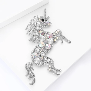 Macro shot of silver unicorn brooch with sparkling clear and rainbow rhinestones