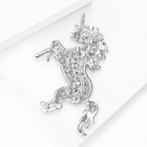 Detailed back view of silver unicorn brooch showing honeycomb cutout and secure pin clasp