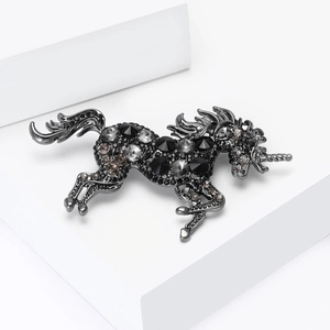 Detail of rhinestone unicorn brooch in gunmetal finish with sparkling crystals