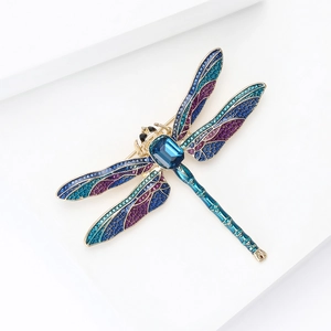Macro shot of dragonfly brooch showing detailed mesh wings with blue and purple enamel