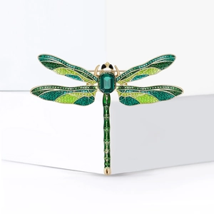 Exquisite enamel dragonfly brooch with green gradient wings and a faceted central gemstone