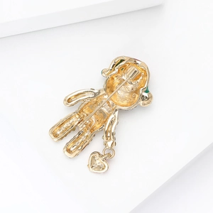Creative alloy Christmas bear brooch with gold plating and heart pendant on white platform