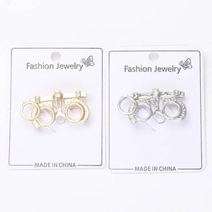 Detailed macro view of creative eyewear brooch with rhinestones on display cards