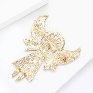 Detailed back view of gold enamel angel brooch showing pin closure and metal texture