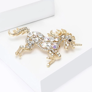 Macro shot of gold-plated unicorn brooch with sparkling crystal rhinestones and fine detail