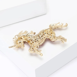 Detailed back view showing the golden hollow grid texture and secure safety pin of the brooch