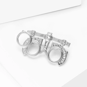 Detailed view of silver optometry trial frame brooch with rhinestones for suits