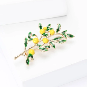 Elegant lemon tree branch brooch with green enamel leaves and yellow fruit on gold metal